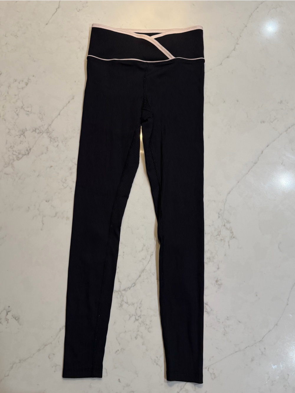 Year of Ours Black Ribbed Leggings with STAY HOT on calves.